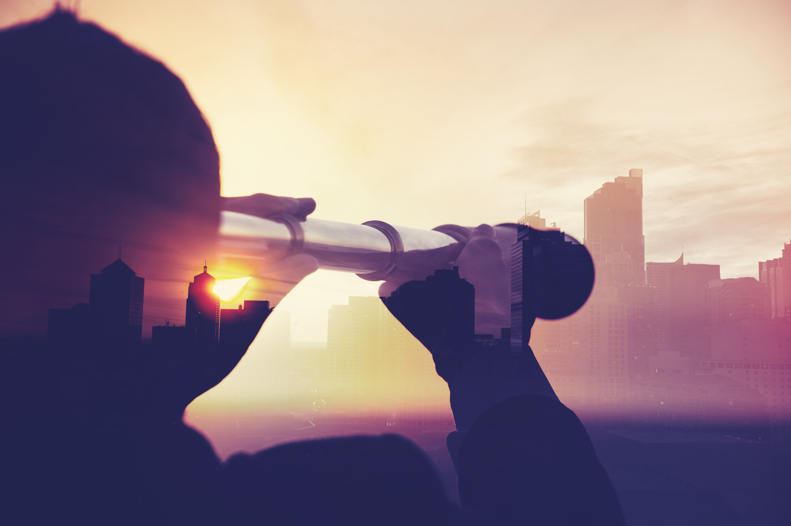 business man holding a telescope looking at the city
