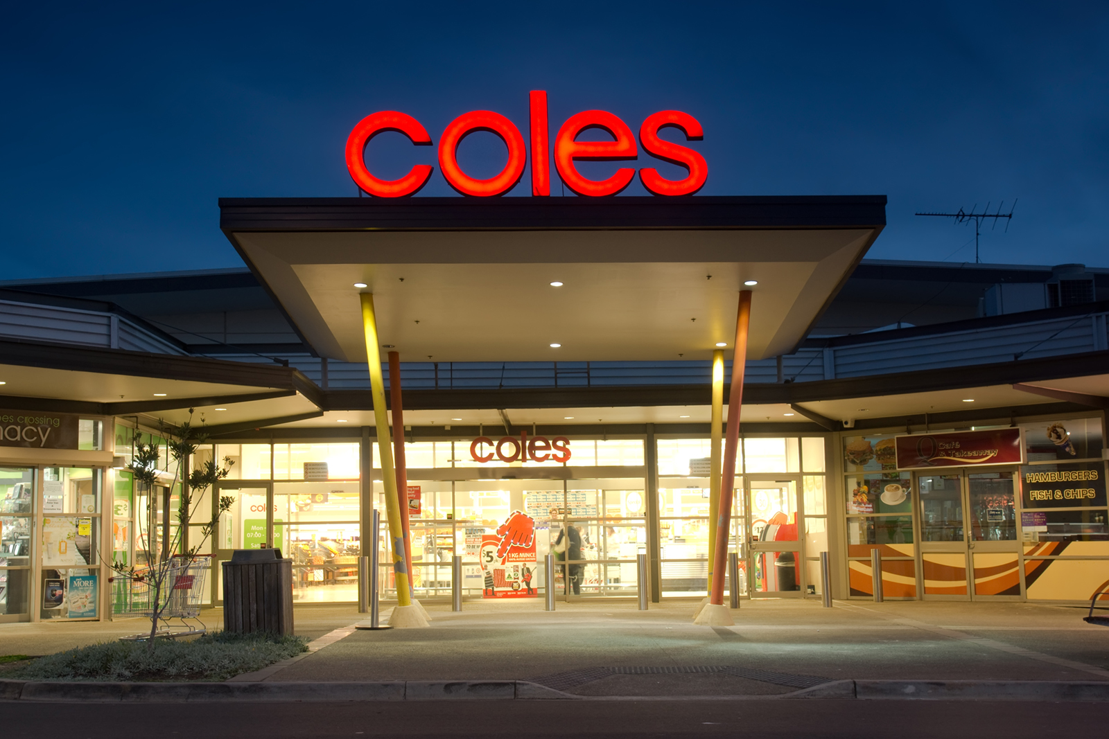 Front of a Coles supermarket at night