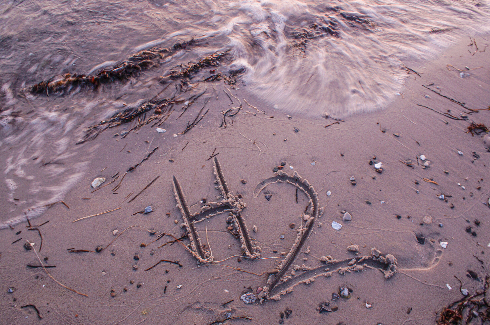 hydrogen elemental symbol written in sand