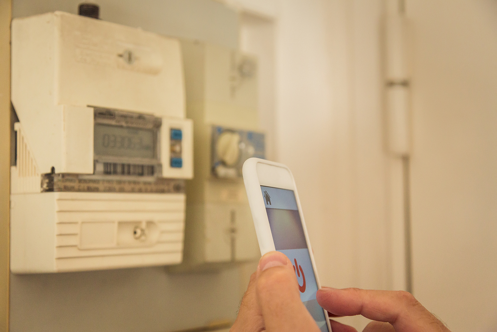 Smart home: man checking electricity consumption on phone